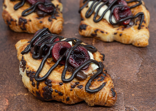 Schulstad Black Forest Chocolate Hazelnut Croissant Recipe with chocolate cream and whipped cream filling, kirsh cherries, and chocolate icing drizzle