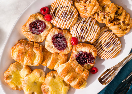 Breakfast Platter Featuring Schulstad Mini Danish Selection including flavors like Cinnamon Swirl, Vanilla Crown, Raspberry Crown, Maple Pecan, and Apple Coronet