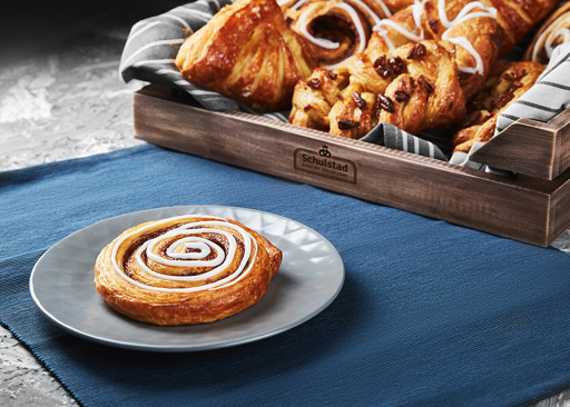 Schulstad Cinnamon Swirl Pastry with other large danish pastries in Background