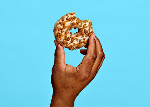 228289 Schulstad Cookie Butter Filled Ring Donut with bite to reveal silky caramel filling