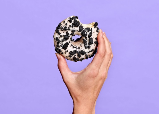 228292 Schulstad Cookies & Creme Filled Ring Donut with bite to reveal smooth cream filling