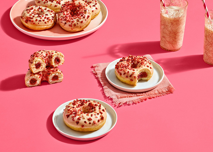 Schulstad Berries & Creme Filled Ring Donuts with raspberry and crème filling. Finished with white frosting & a sprinkle of dried strawberry