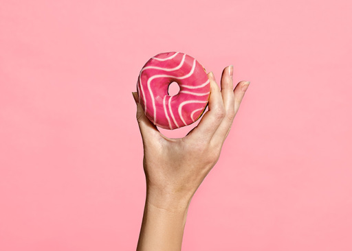 228288 Schulstad Pink Bliss Filled Ring Donut with sweet strawberry flavored filling, topped with pink frosting and a white drizzle