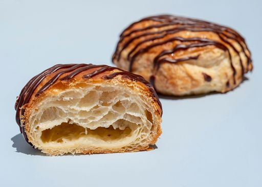 Schulstad Almond Danish Doughnut Pastry Hybrid with filled with creamy almond remonce blend and finished with chocolate icing