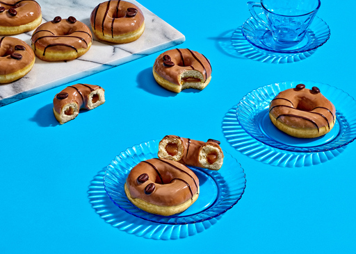 Ready-to-eat Cappuccino Filled Ring Donuts filled with rich cappuccino crème and topped with coffee-colored frosting and two chocolate coffee beans