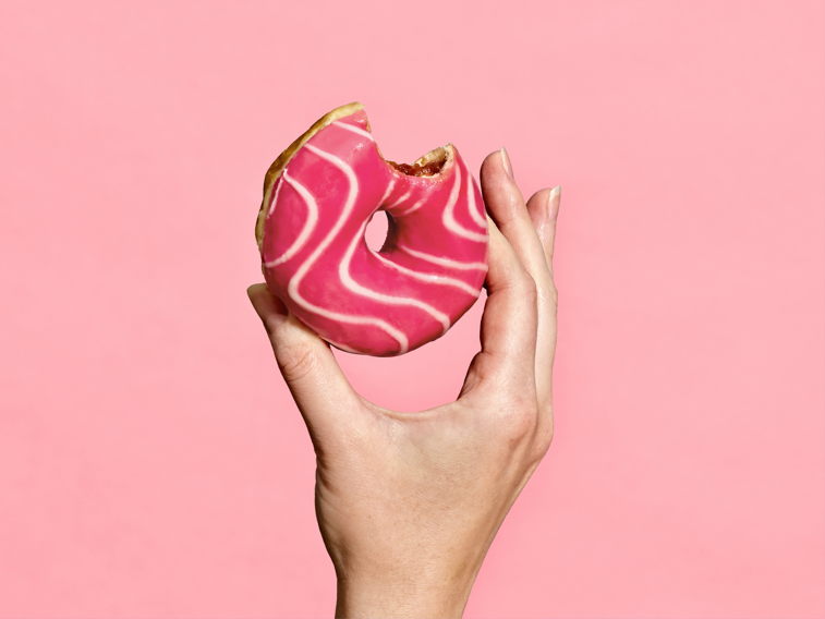 Hand Holding Schulstad Pink Bliss Filled Ring Donut